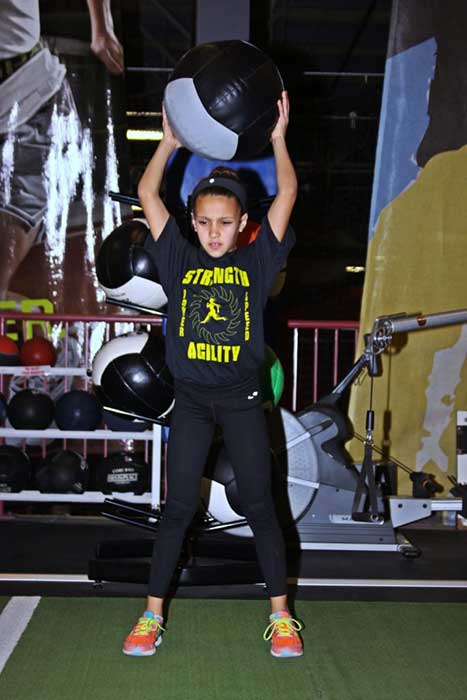 Small girl undergoing strength training